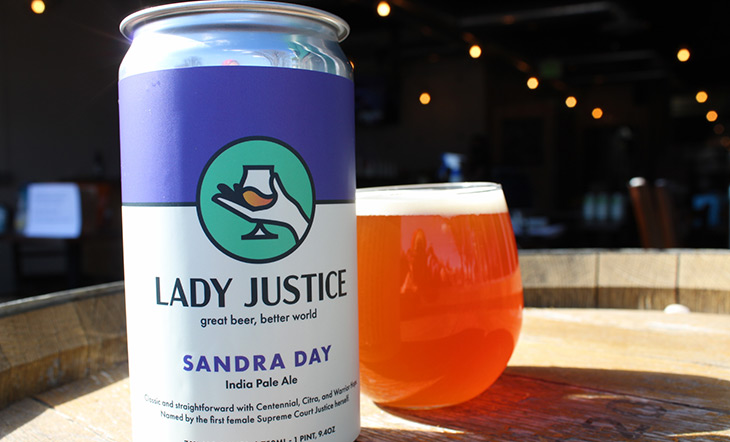 Image of Sandra Day IPA Beer with glass sitting on a barrel